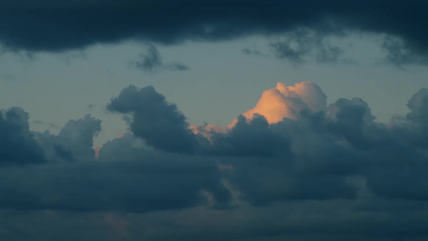 Time lapse panoramic view of clouds rolling in the evening sky