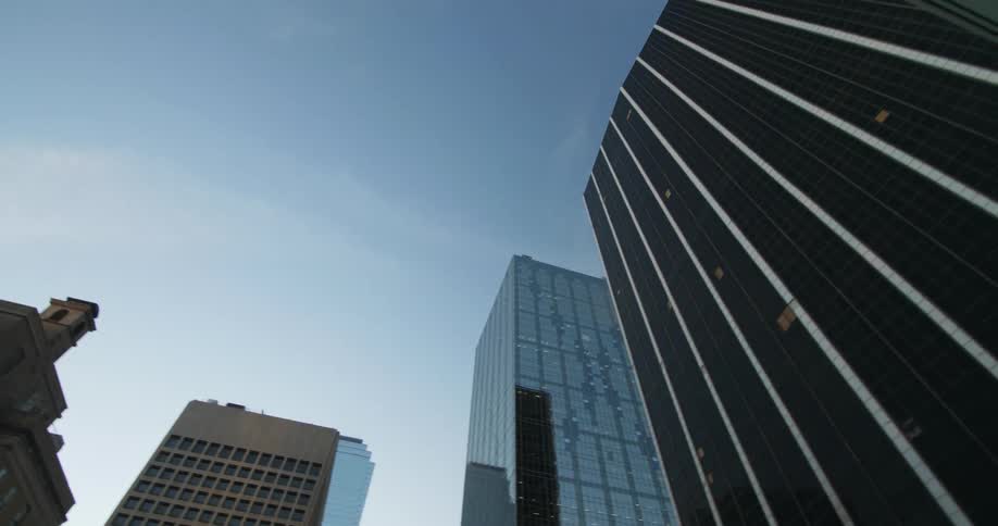 View looking up at skyscrapers on a cloudy day