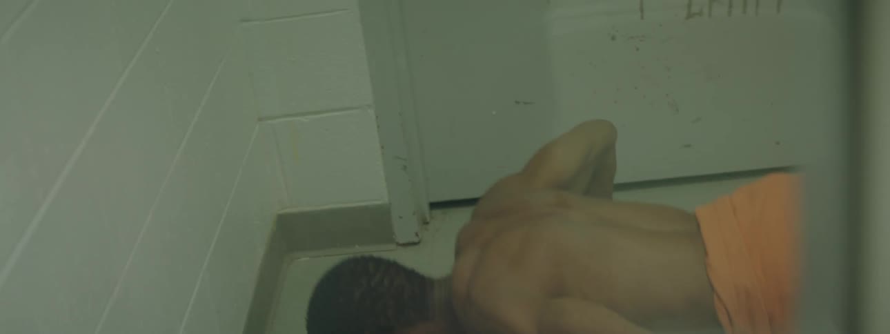 A man is pacing in a prison cell