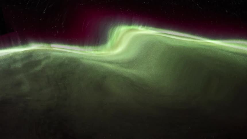 Distorted footage of the green northern lights waves in the night sky