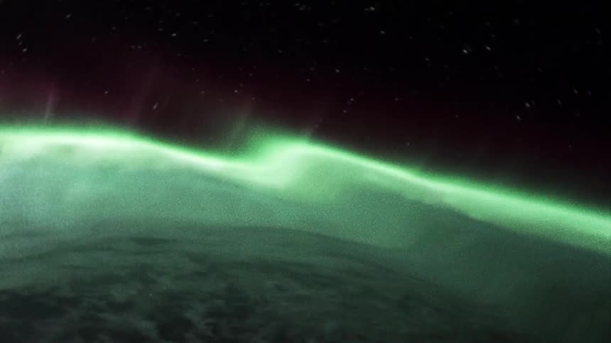 Cosmic footage of earth seen through refractive grating with green color bending in a really cool way