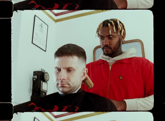 A young man is giving another guy a hair cut