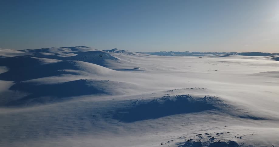 Aerial view of mountains during winter at dusk