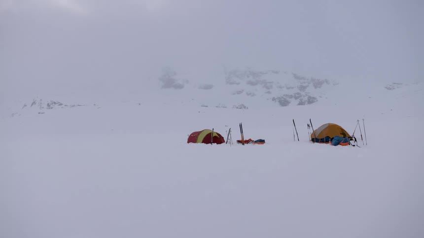 People are camping in an arctic area during winter