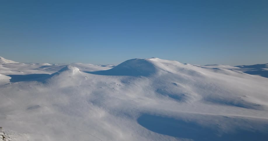 Snow covered mountains in the arctic during the day