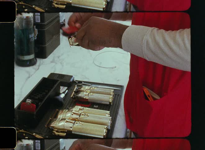 A barber uses a toothbrush to clean his electric razors