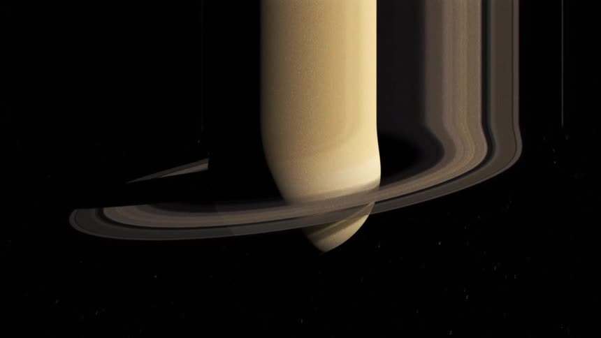 Distorted footage of the planet saturn and its rings floating in space