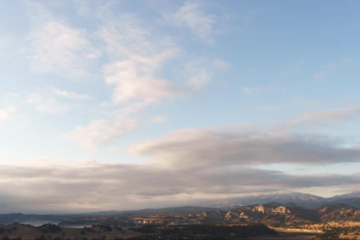 The sun is setting in the horizon of the landscape