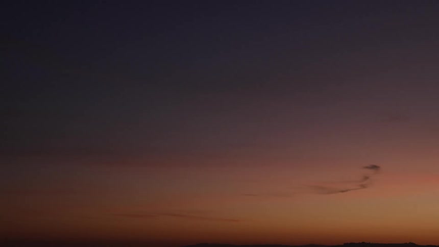 The sky darkens as the sun sets