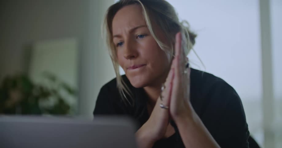 Woman working in office considers what to type next