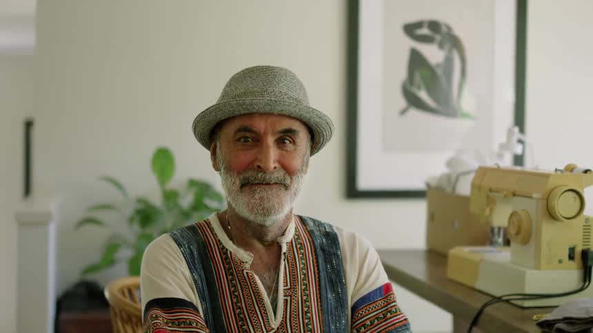 Portrait of a man smiling and wearing a hat