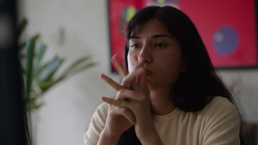 Young woman is inside of her office and looks upset