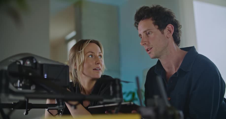 Two people are talking to each other and there is a camara in front of them