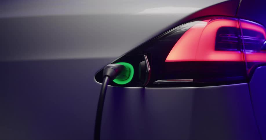 Close up of the pulsing green light on the charging port of an electric vehicle