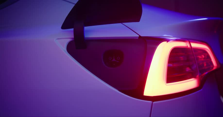Close up view of the charge port of an electric car as it opens up for charging