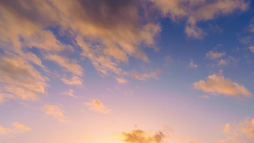 A time lapse of clouds rolling through the sky as the colors change from daylight to dusk to night