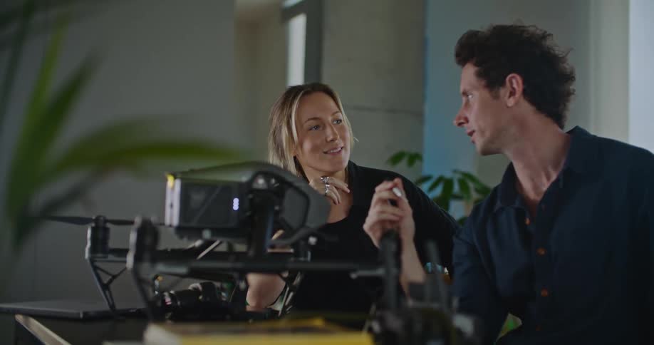 Man and woman discuss drone while sitting in office