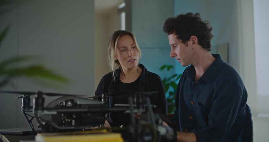 Man and woman are talking and building a machine