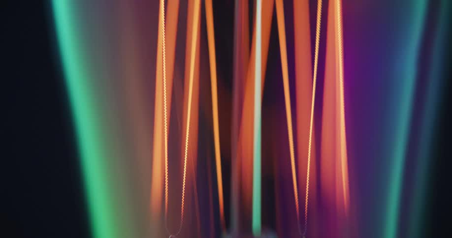 Shifting colorful lights floating against a black background