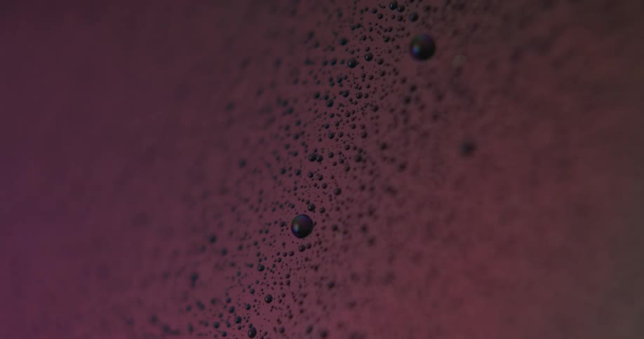 A close up of white bubbly foam with multi colored lights flashing across it