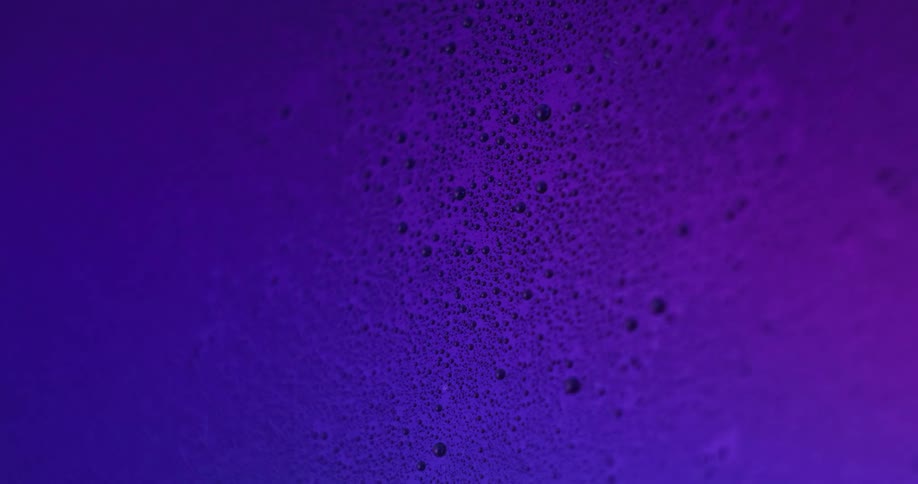 A close of a textured wall with lights flashing on it