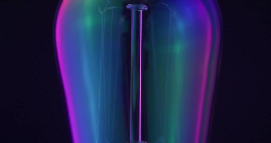 Iridescent colors move across surface of lightbulb before filament starts to glow