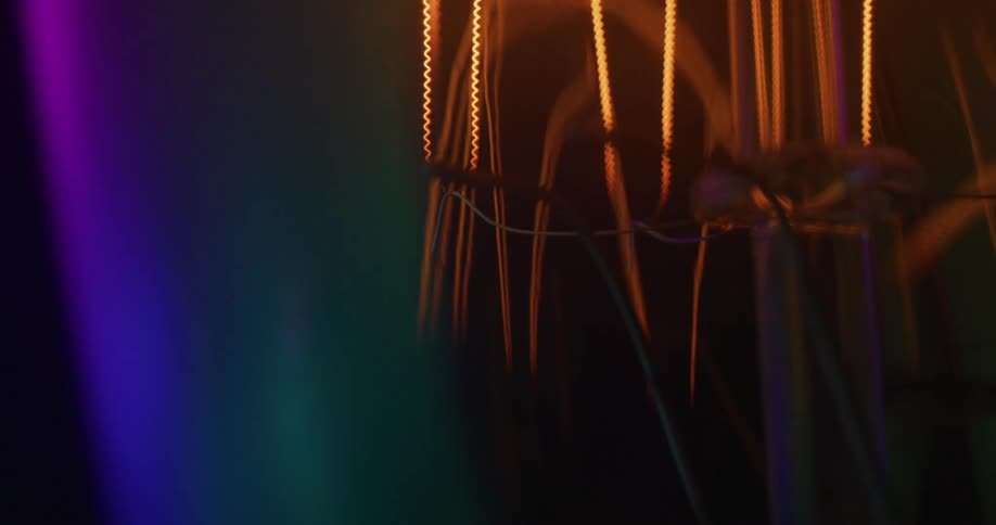 Abstract closeup of wires and filaments with refraction grating prism colors against black