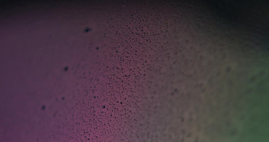 A purple light shines on a textured floor