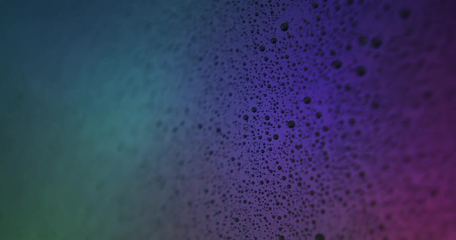 An up close of bubbly white foam with colored lights flashing over it