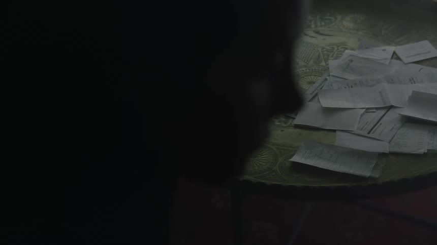A woman is sitting in a room by herself