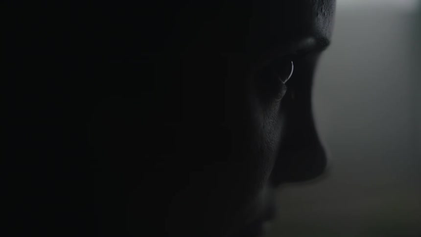 Close up view of a womans face while she sits indoors