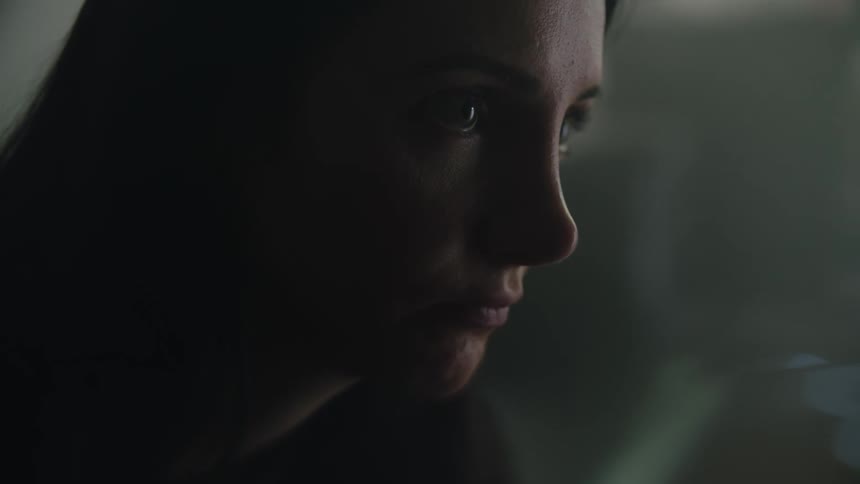 Portrait of a woman sitting indoors near a window