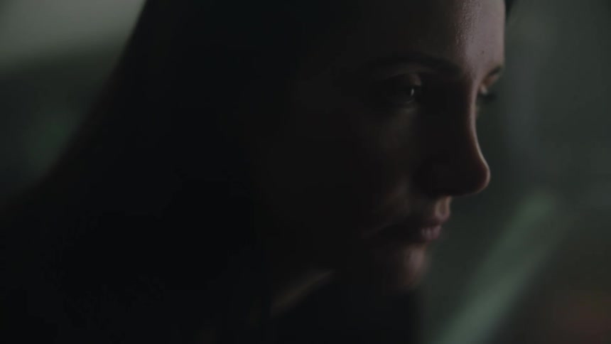 A silhouette of a side profile of a womans face as she looks ahead