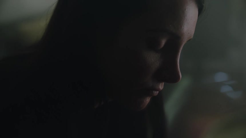 Close up view of a woman sitting in a room by herself