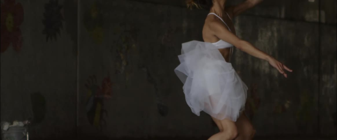 Woman jumps up doing dance moves
