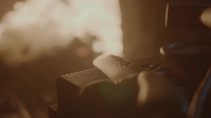 A fire burns in the background and a knife is shown