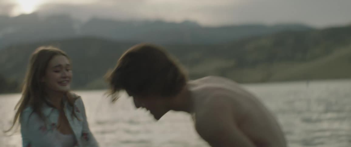 A couple playing and splashing around  in a lake