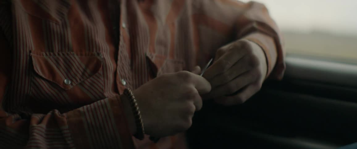 Man self manicuring while riding in a vehicle