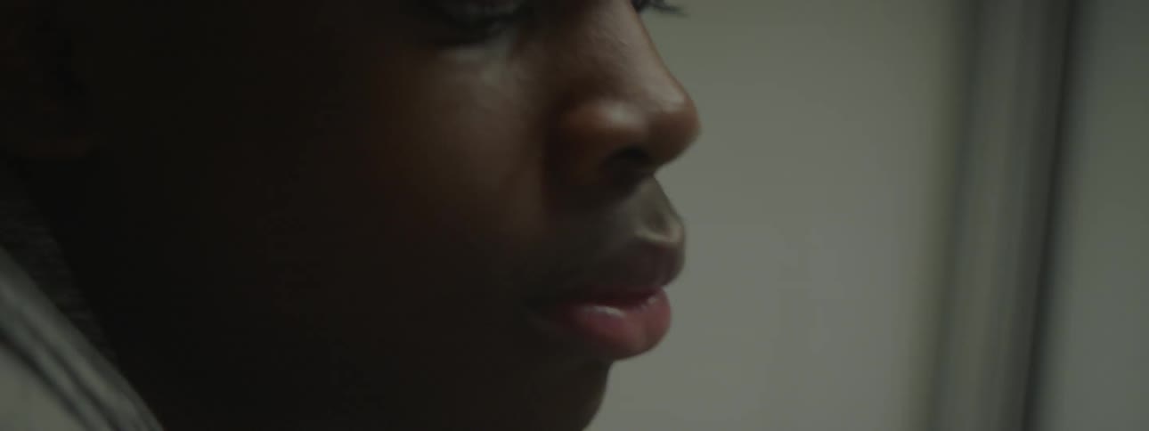 A boy scratches paint off of a wall