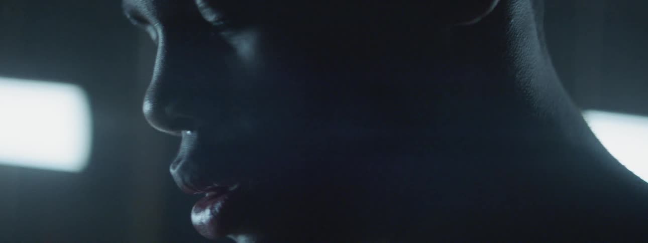 A man sits in the dark with his eyes closed