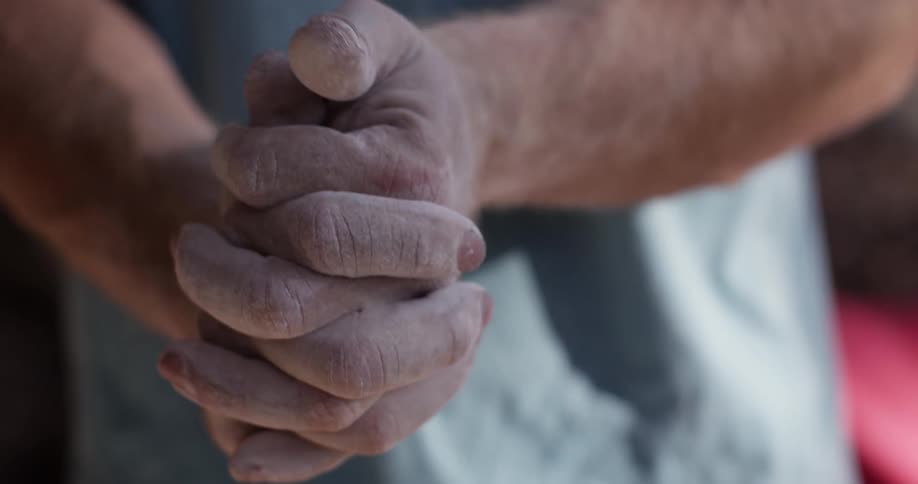 A man rubs his hands together