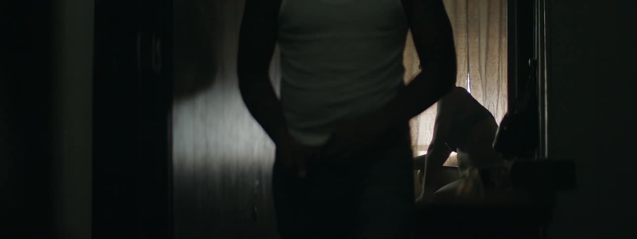 A man smokes in front of a tv