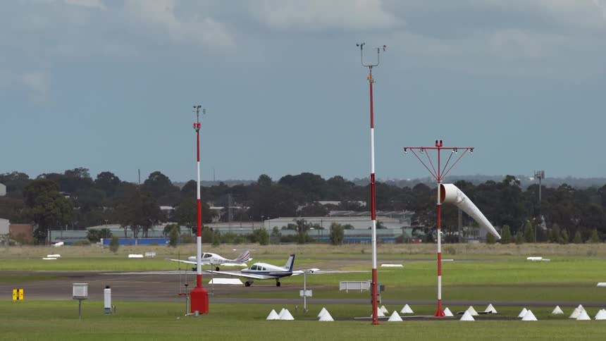 A small plane begins a take-off from an airfield