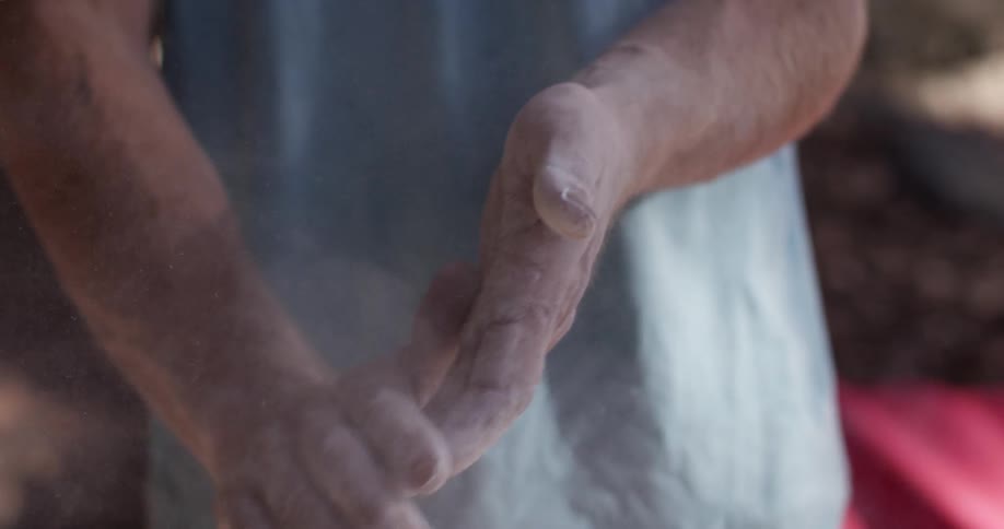 A man wipes his hands together