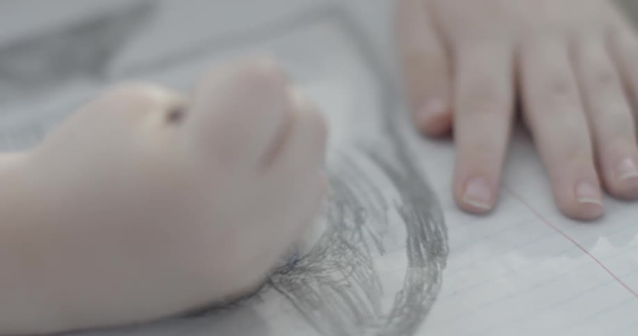 A child is drawing with a pencil