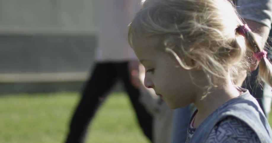 Children are walking with their parents on a sunny day