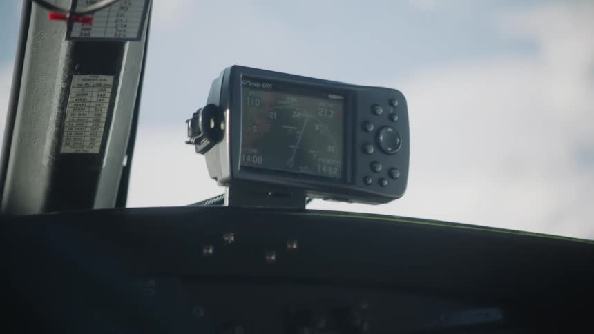 A navigation device is on the dashboard near a window