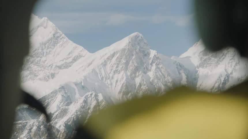 View of snow covered mountains from a helicopter window
