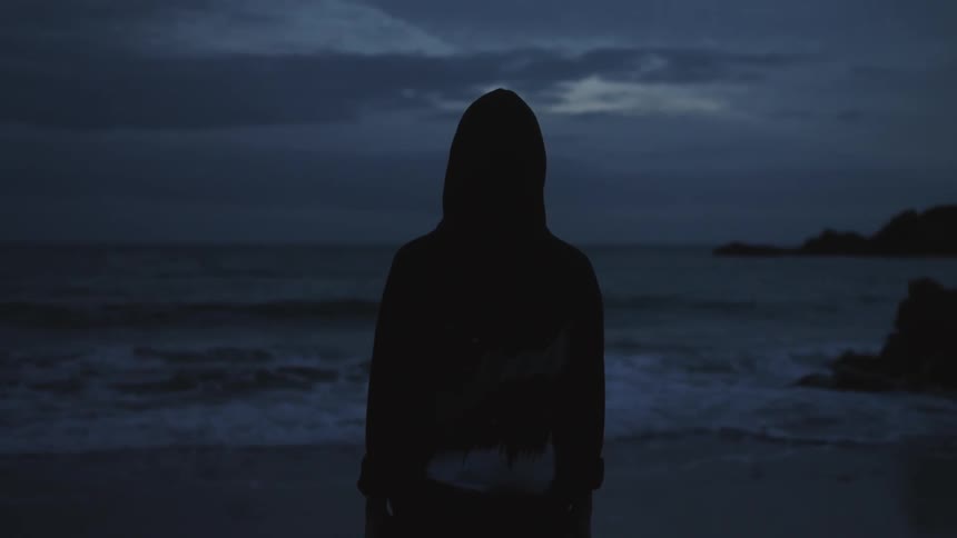 A view of a person standing out near the ocean