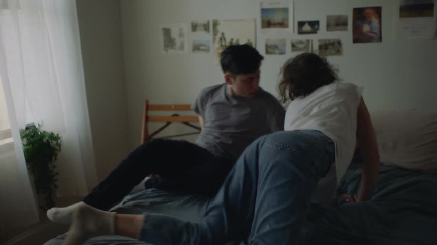 Romantic young couple cuddling in bed perform a seductive interpretative dance at home